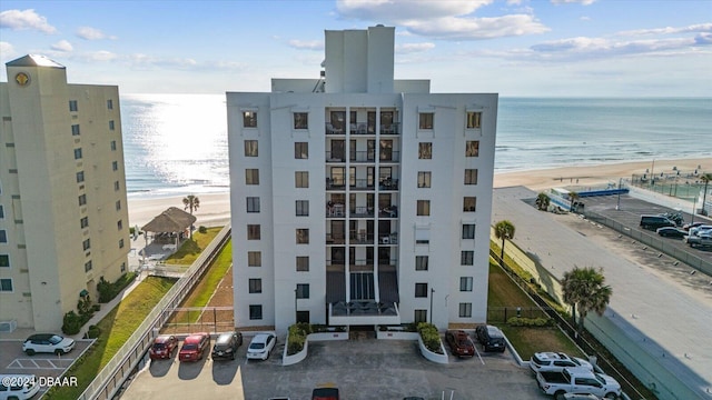 view of building exterior with a view of the beach and a water view