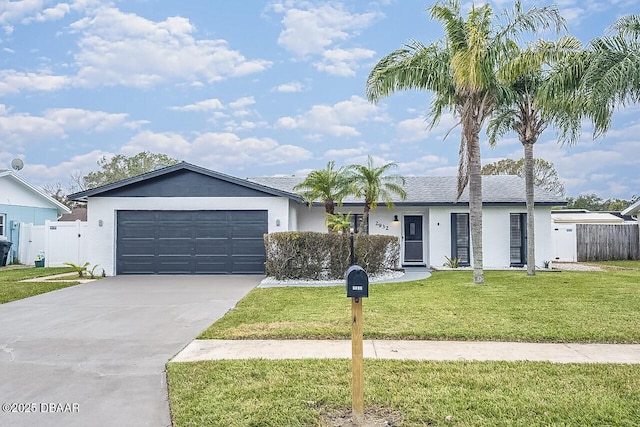 ranch-style home featuring a garage and a front lawn