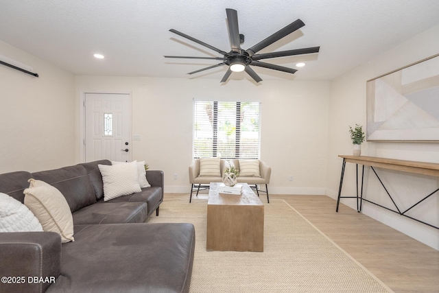 living room featuring light hardwood / wood-style flooring and ceiling fan