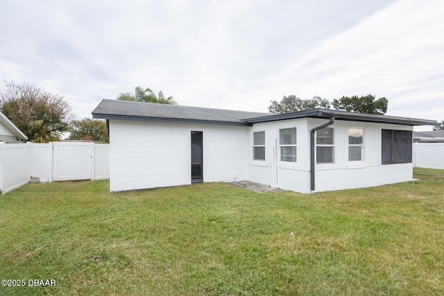 rear view of house with a yard