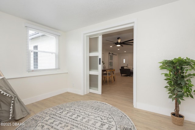 interior space with ceiling fan and light wood-type flooring