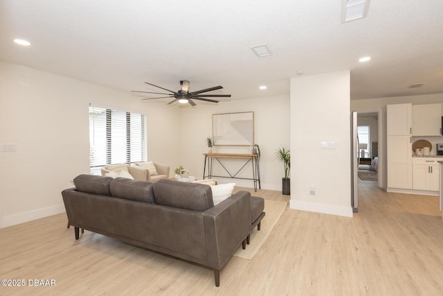 living room featuring ceiling fan and light wood-type flooring