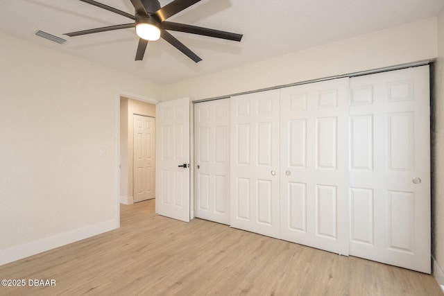 unfurnished bedroom with ceiling fan and light wood-type flooring