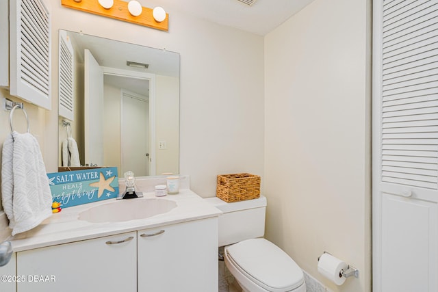 bathroom with toilet and vanity