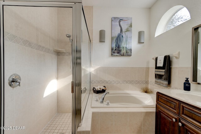 bathroom featuring vanity and independent shower and bath