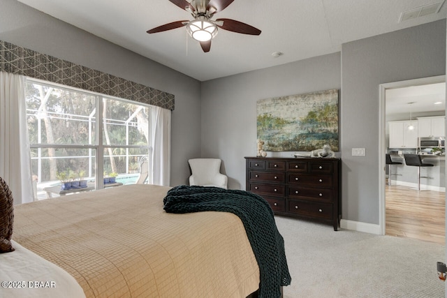 bedroom with light carpet and ceiling fan