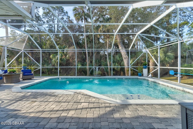 view of pool featuring a patio and glass enclosure