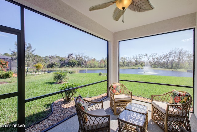 sunroom / solarium featuring a water view and ceiling fan