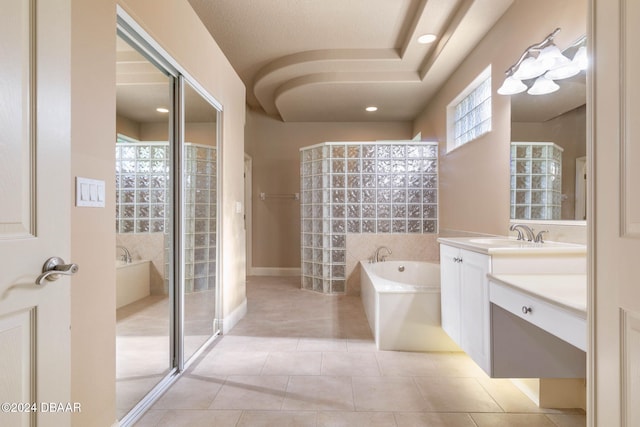 bathroom featuring vanity, tile patterned floors, tile walls, and separate shower and tub