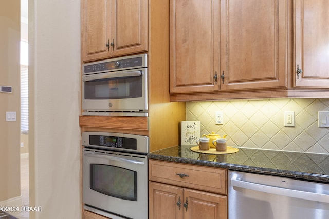 3404 Rexford Cir, Ormond Beach, FL 32174 - kitchen featuring stainless steel appliances, backsplash, dark stone countertops, and baseboards