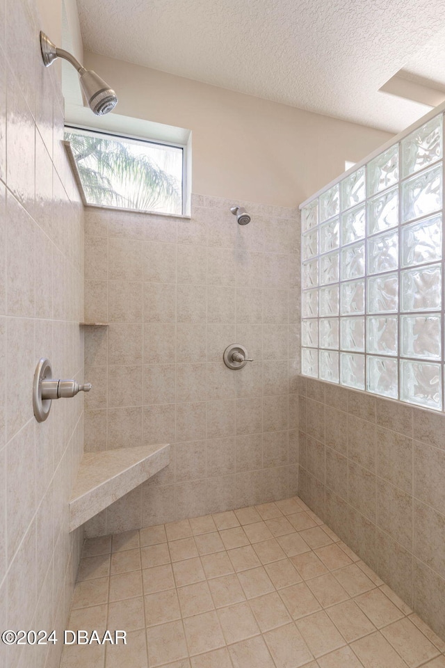 3404 Rexford Cir, Ormond Beach, FL 32174 - full bath with tiled shower, a textured ceiling, and tile patterned flooring