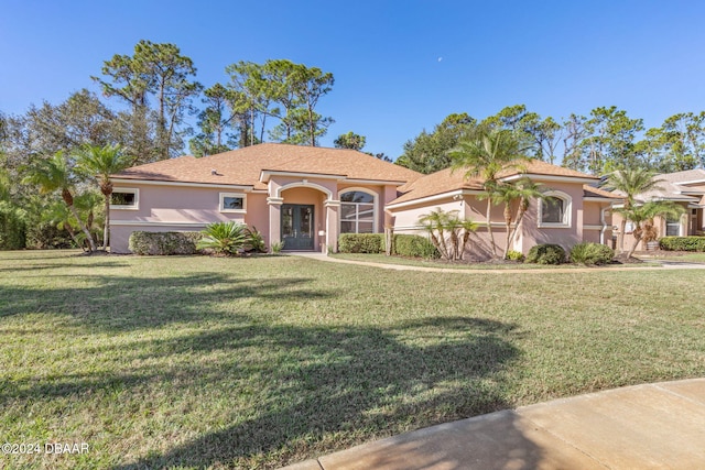 mediterranean / spanish-style home with a front yard