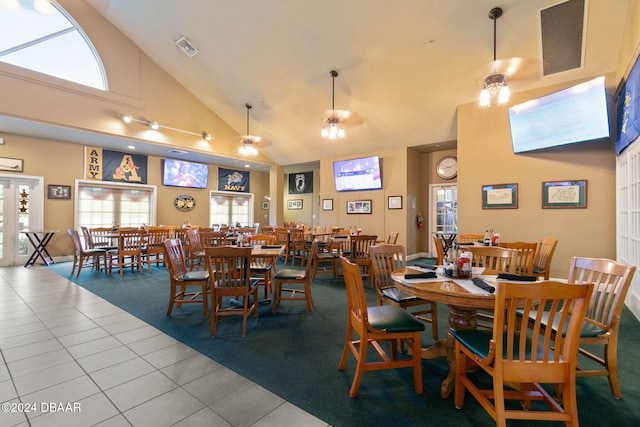 3404 Rexford Cir, Ormond Beach, FL 32174 - tiled dining room featuring high vaulted ceiling, carpet, and healthy amount of natural light
