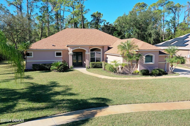 3404 Rexford Cir, Ormond Beach, FL 32174 - mediterranean / spanish house featuring stucco siding, a front yard, french doors, and roof with shingles