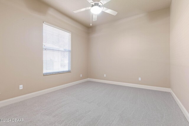 empty room with carpet flooring and ceiling fan