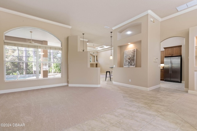 3404 Rexford Cir, Ormond Beach, FL 32174 - unfurnished living room featuring crown molding, light tile patterned floors, baseboards, arched walkways, and light colored carpet