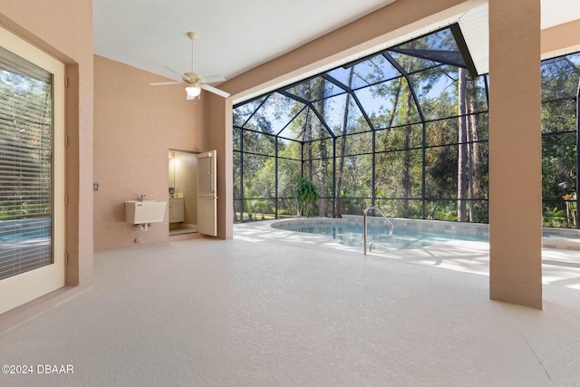 view of swimming pool featuring ceiling fan and sink