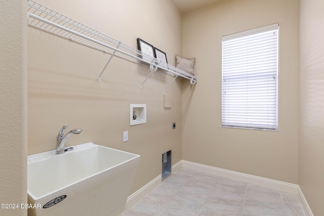 washroom with hookup for an electric dryer, sink, and hookup for a washing machine