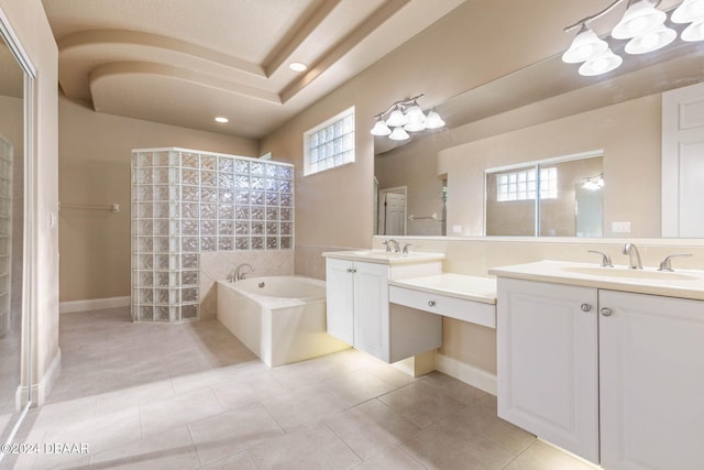 bathroom featuring plus walk in shower, tile patterned flooring, and vanity