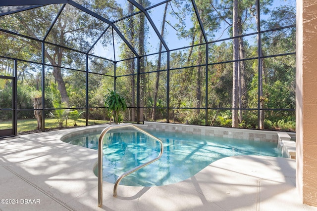 view of swimming pool featuring a patio and a lanai