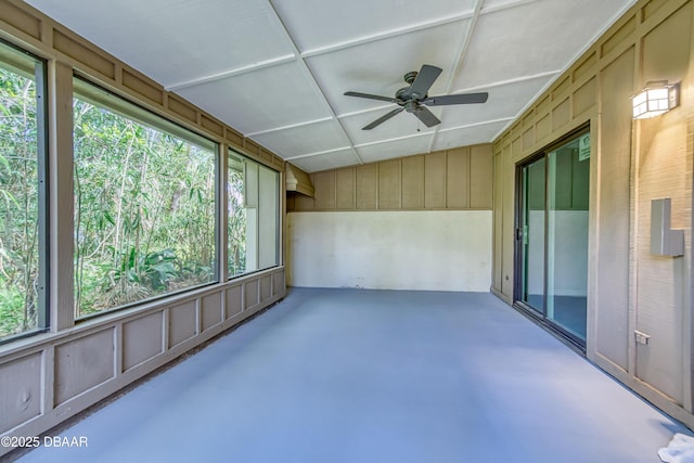 unfurnished sunroom featuring ceiling fan