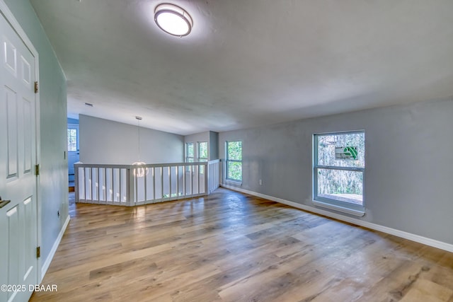 unfurnished room featuring light wood-style flooring and baseboards