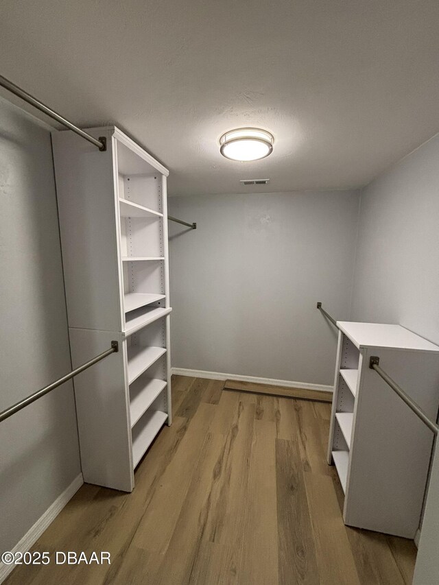 bathroom featuring vanity, tile patterned flooring, and a tile shower