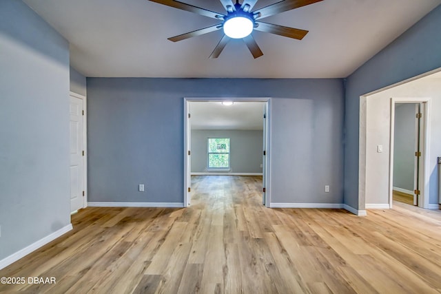 unfurnished room featuring baseboards, ceiling fan, and light wood finished floors