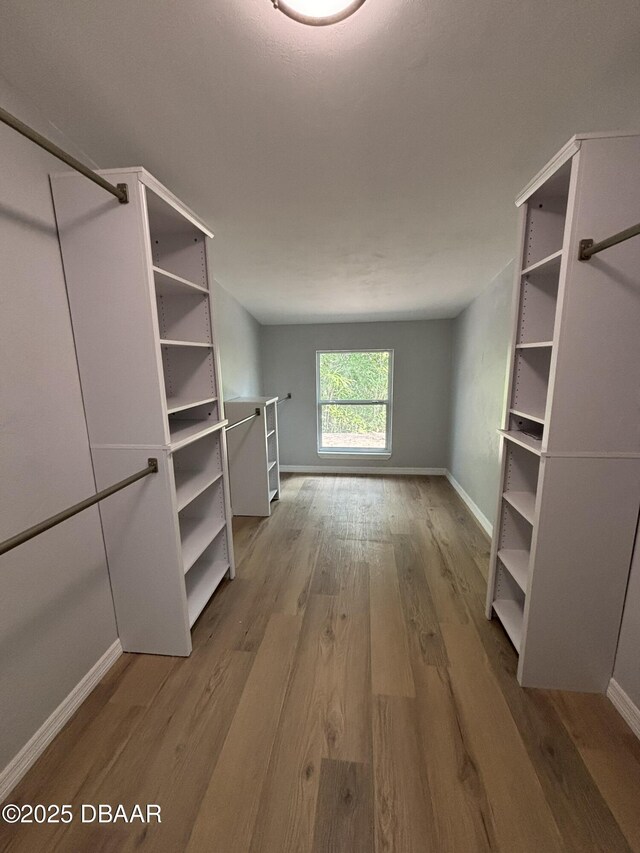 spacious closet with wood finished floors