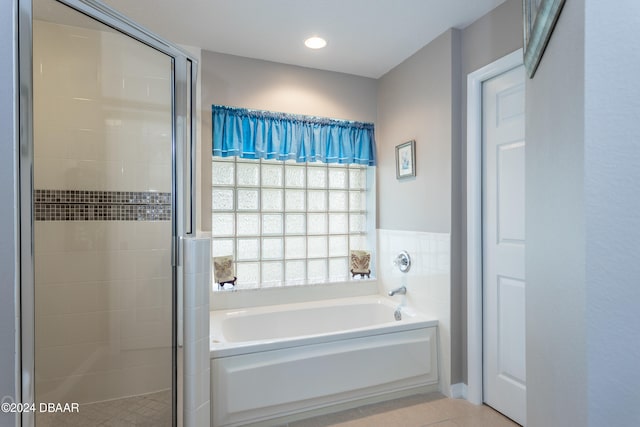 bathroom with tile patterned floors and independent shower and bath