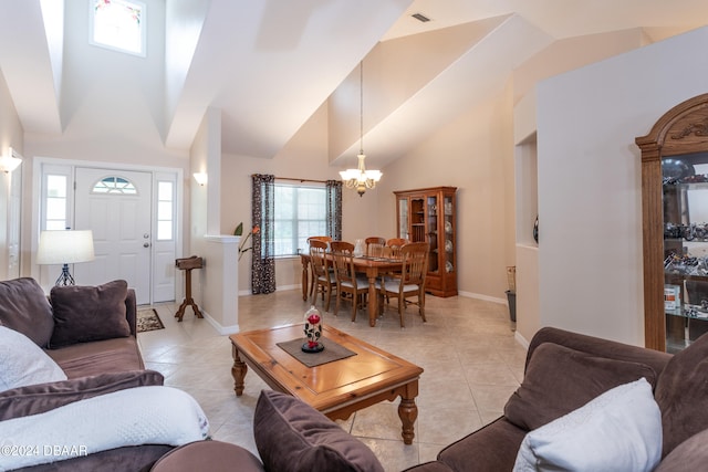 tiled living room featuring a notable chandelier and high vaulted ceiling