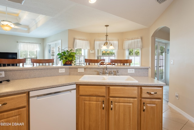 kitchen featuring french doors, white dishwasher, sink, light tile patterned floors, and hanging light fixtures