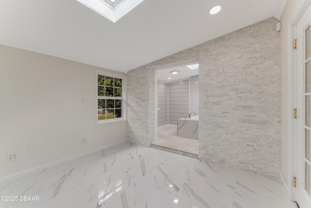 bathroom featuring vaulted ceiling with skylight