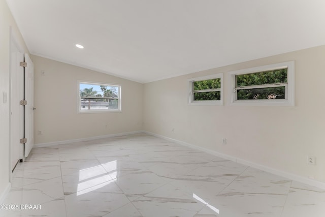 empty room featuring lofted ceiling