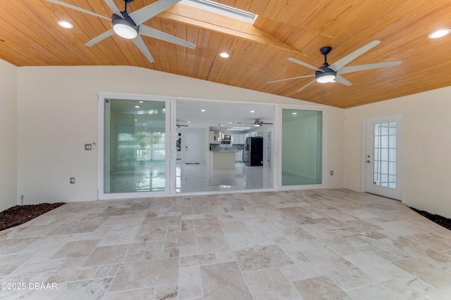 spare room with wooden ceiling and vaulted ceiling with skylight