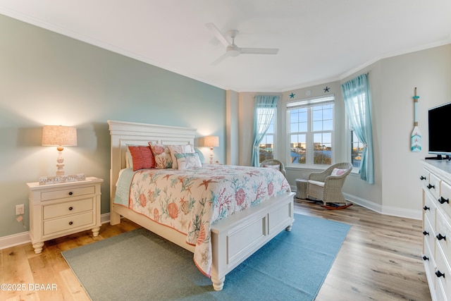 bedroom with light hardwood / wood-style flooring, ornamental molding, and ceiling fan