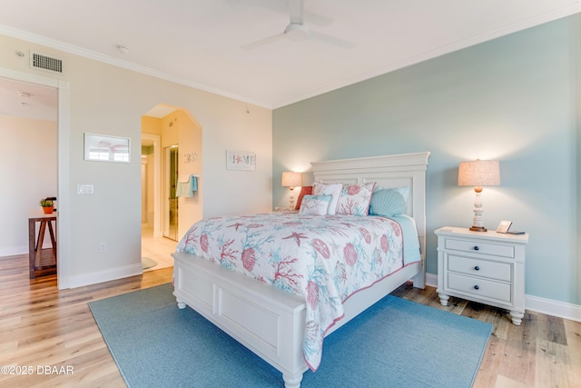 bedroom featuring crown molding, ceiling fan, ensuite bathroom, and light hardwood / wood-style flooring