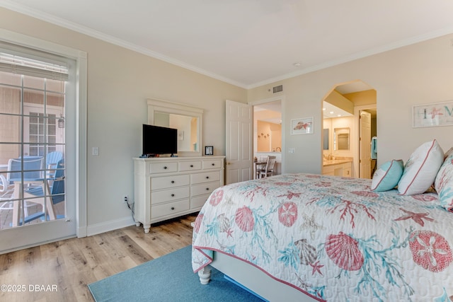 bedroom with crown molding, ensuite bath, light hardwood / wood-style floors, and access to outside