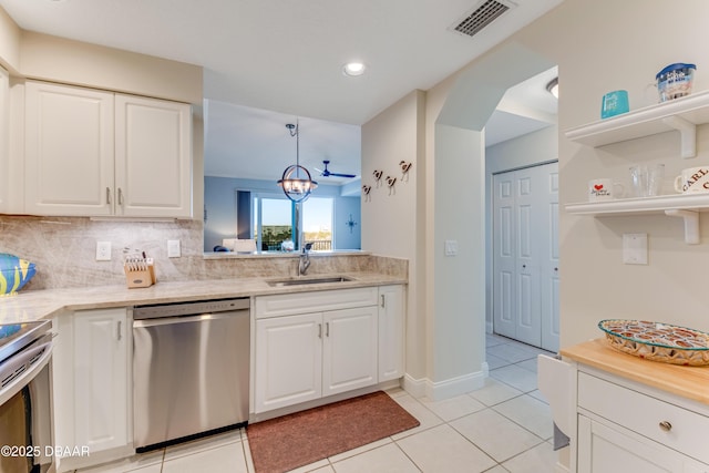 kitchen featuring white cabinetry, sink, pendant lighting, and appliances with stainless steel finishes