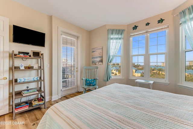 bedroom featuring access to outside and light hardwood / wood-style floors