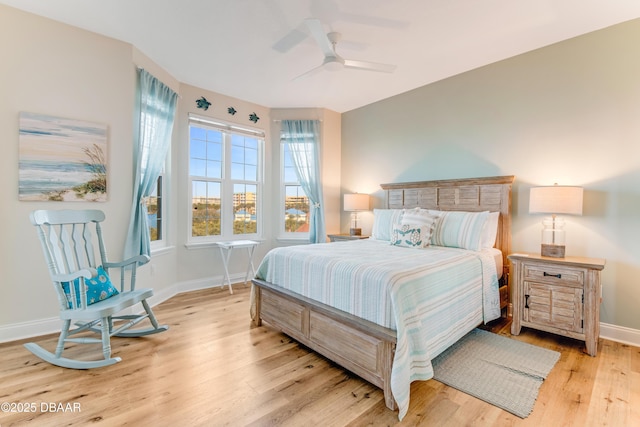 bedroom with ceiling fan and light hardwood / wood-style floors