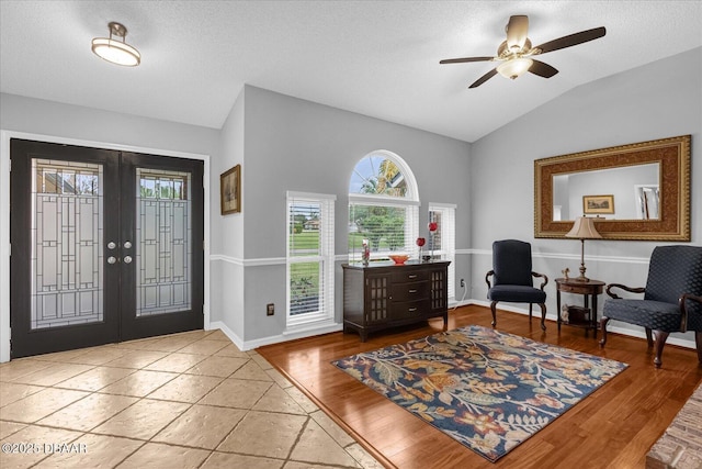 foyer entrance with ceiling fan, vaulted ceiling, french doors, and hardwood / wood-style floors