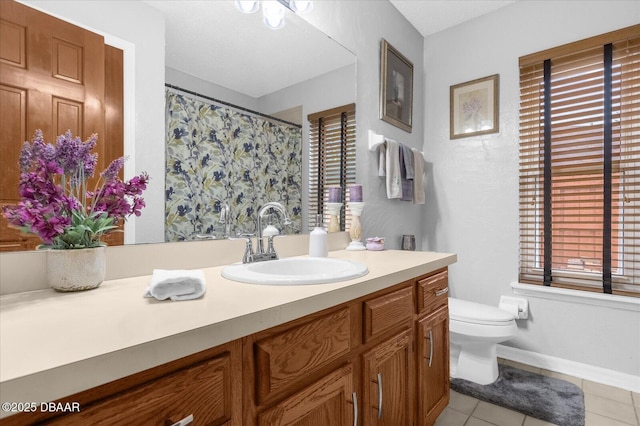 bathroom with toilet, tile patterned floors, and vanity