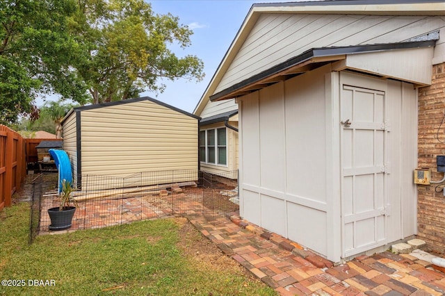 view of property exterior with a yard and a storage unit