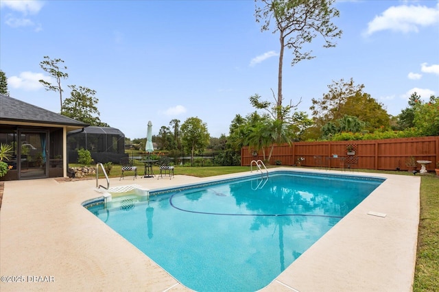 view of swimming pool with a patio area and a lanai