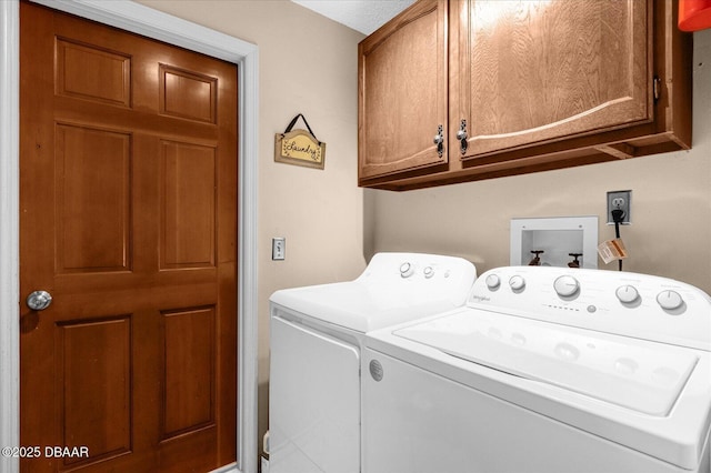 washroom featuring washing machine and dryer and cabinets