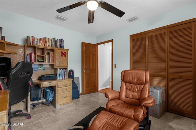 office with ceiling fan, light tile patterned floors, and a textured ceiling