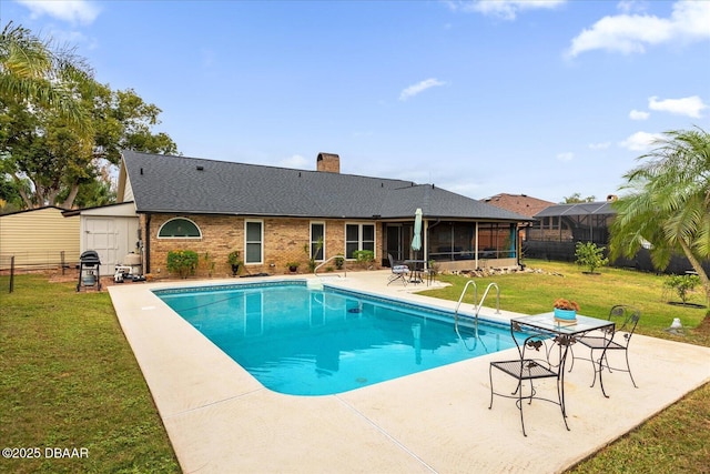 view of swimming pool featuring a sunroom, a lawn, grilling area, and a patio