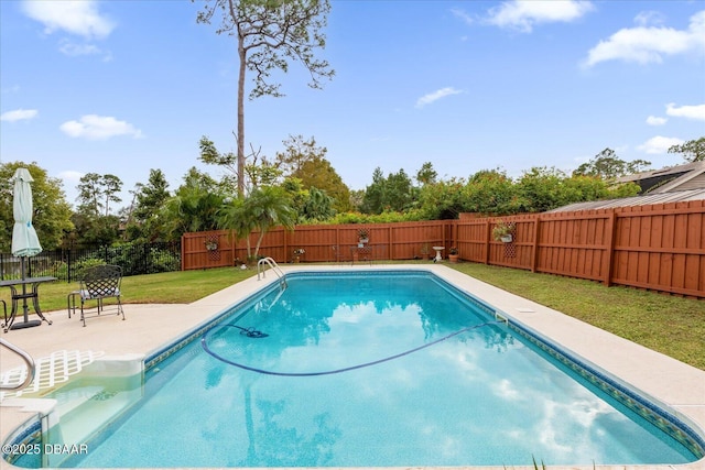 view of pool featuring a lawn and a patio area