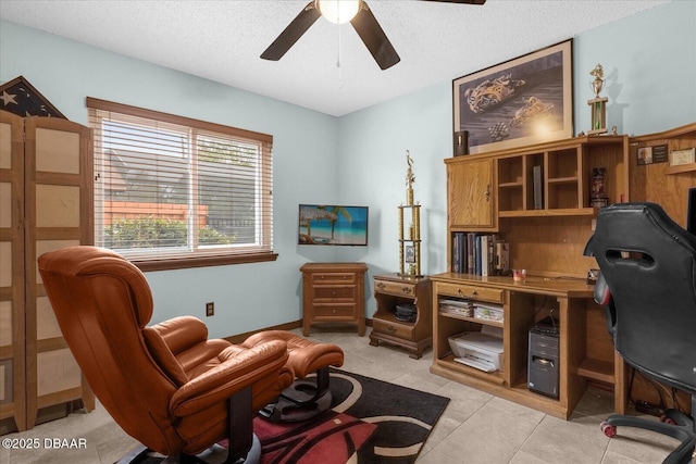 tiled office with ceiling fan and a textured ceiling